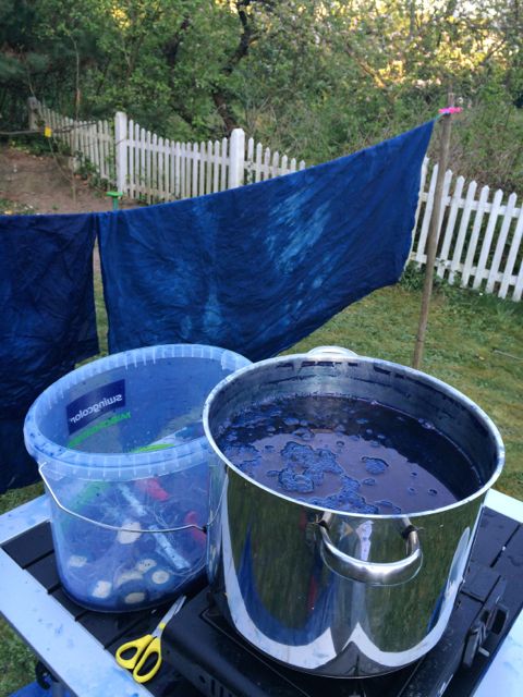 Indigo dye vat on gas camping stove in the garden.